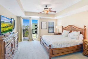 Primary Suite with Ocean-Facing Balcony – King Bed + View - Wake up to palm trees and ocean glimpses in this bright, spacious primary suite. Features a plush king bed, direct balcony access, and a flat-screen TV—perfect for slow mornings and salty breezes.