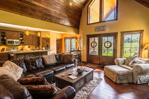 Living room with leather and suede furniture, gas log fireplace and TV