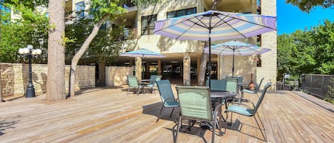 Large community deck with seating, overlooking the Comal & pool.