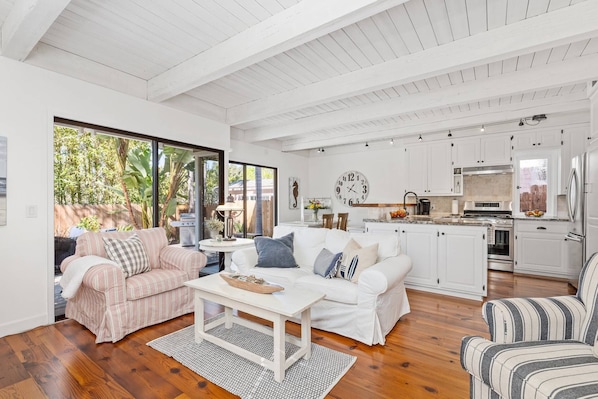 Living room with comfortable seating, kitchen and dining area