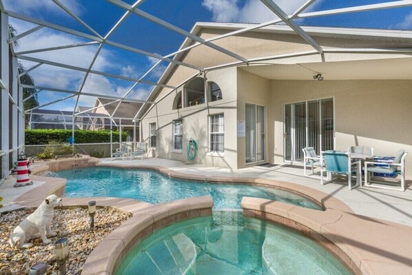 Relax by the private screened-in pool with crystal-clear water and ample lounging space.