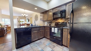 Upgraded kitchen with black appliances.