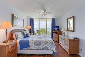 Master Bedroom with King Size Bed, Flat Screen TV, and Access to Private Covered Balcony