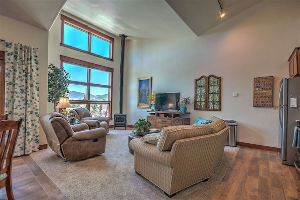 Lots of natural light from the windows, along with a cozy fireplace and big screen TV