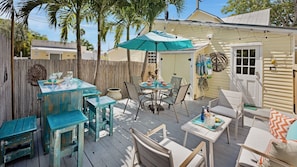 The sun deck is completely private and features an outdoor lounging set and high top bar...