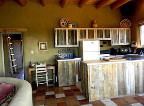 Custom designed kitchen cabinets of local soft and hard woods, hand crafted by local artist