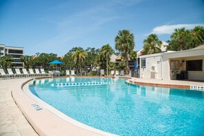 Deep end of the large swimming pool with plenty of loungers to relax upon