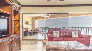 The living room is next to the sliding doors onto the balcony.