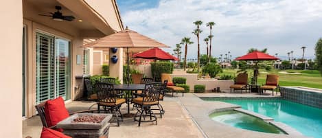 Patio and Pool Area - seating of 6 on round table - 3 chairs, 4 lounge chairs, and an umbrella