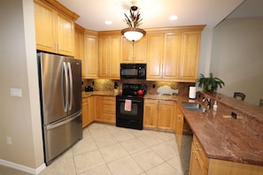 Fully Equipped Kitchen Opens up to the Dining and Living Room