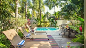 The private dip pool is heat-optional and surrounded by lush landscaping...