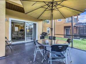 Outdoor dining area under a large umbrella, perfect for enjoying meals in the fresh air.