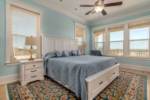 Primary bedroom with a king sized bed, overlooking the beach in Dauphin Island.