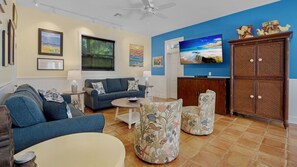 The living room has plenty of seating for everyone, with plush sofas and armchairs...