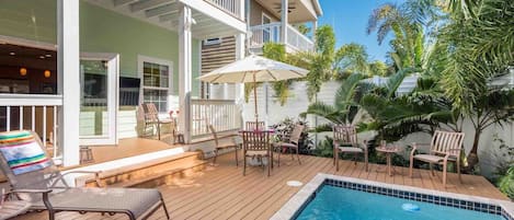 The fully fenced private back pool area with chaise lounges and outdoor dining...