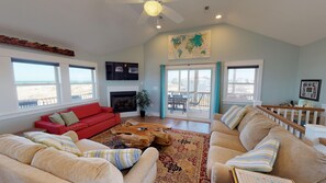 Living room, screened porch beyond.