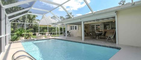 Tropical heated outdoor pool area provides an abundance of entertaining space for guests, as well as BBQ (propane/gas) grill for outdoor cooking.
