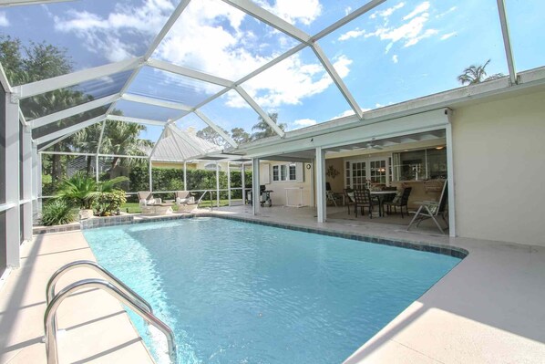 Tropical heated outdoor pool area provides an abundance of entertaining space for guests, as well as BBQ (propane/gas) grill for outdoor cooking.