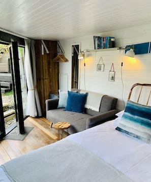 Kingsize bed and comfy 2 seater sofa looking out onto the garden