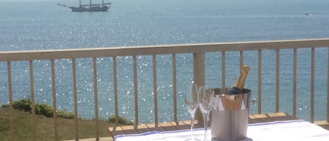 Front balcony with stunning views, dining table, chairs and quality sunloungers