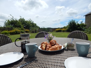 The garden is sunny and welcoming, and overlooks the lake beyond.