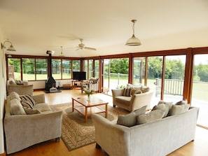 Openplan living/dining  room overlooks the lake, with 3 doorways onto the patio