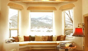 Living room bay window with grand mountain / pasture views
