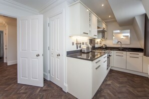 Kitchen leading to lounge and dining area