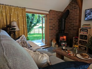 Cosy sitting room area with view of woodland and meadow