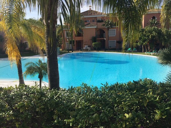 View of pool from apartment private garden