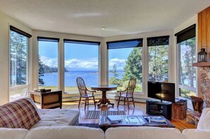 Well appointed living room with incredible views and a grand piano.