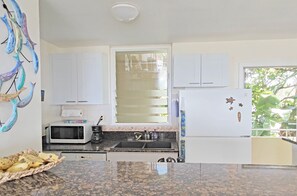 Airy galley kitchen with louvered window