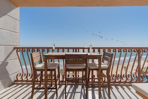 Birds fly by as you enjoy the beach from up above.