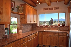 Large fully equipped gourmet kitchen with mountain views & "counter pass through" for efficient meal serving & clean up