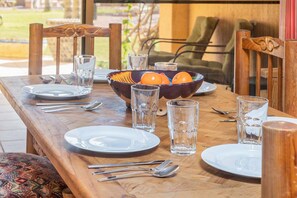 Dining table right by the patio door lets you enjoy the beauty outdoors.