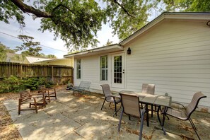 Private Patio with Seating – Fenced St. Simons Island Rental - Whether it’s coffee at sunrise or wine under the oaks, this fenced backyard patio offers outdoor dining space and seating just outside your pet-friendly St. Simons vacation home.