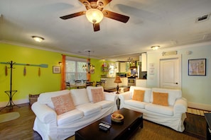 Full Living Space View – Open Layout Near Pier Village - Everything flows at 1049 Oceanview. This full view shows off the bright open layout from the living area to the kitchen—ideal for keeping the crew connected whether you’re cooking, relaxing, or getting ready for a beach day.