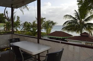 Beach front patio overlooking the garden and gazebo.