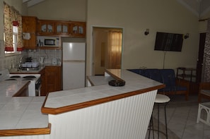 Kitchen area with electric cooker & bar seating