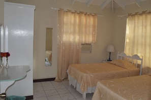 Air conditioned bedroom with 2 twin beds, en suite bath + beach front bay window