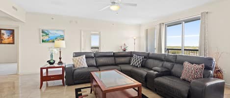 Living Room with Reclining Sectional and Balcony Access