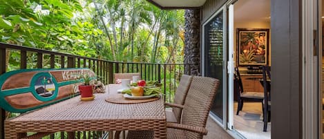 comfortable seating for 4 people on the lanai - beautiful garden setting, with water fall below.