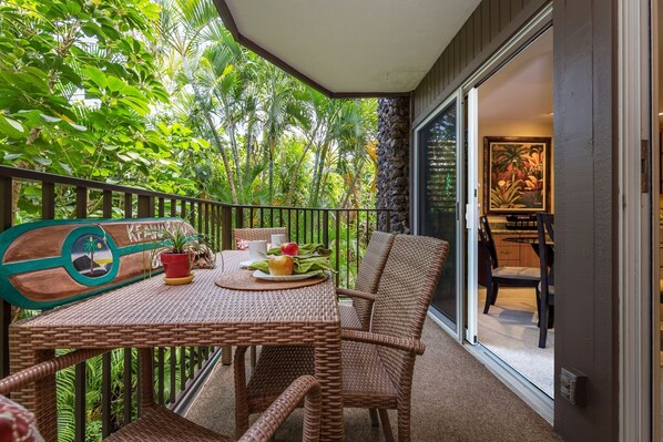 comfortable seating for 4 people on the lanai - beautiful garden setting, with water fall below.