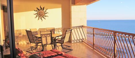 Balcony - outdoor dining table, chaise lounge chairs and plenty of seating.