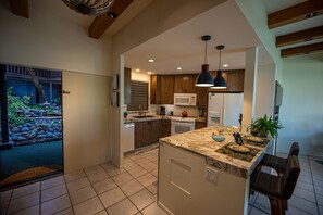 Kitchen with bar stools at the counter