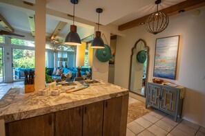 Kitchen with bar stools at the counter and ocean view