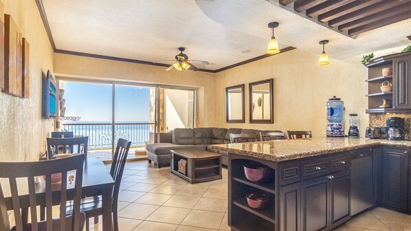 Spacious main room with lots of wood in the kitchen, and earthy tones throughout.