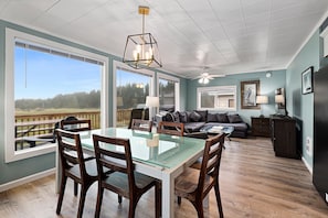 The dining area showcases a wooden table with seating for six.