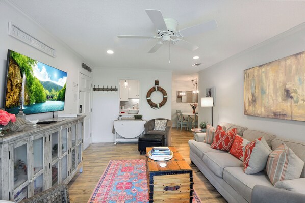 Picture Name: Living Room – Ocean Walk J-11 - Bright and breezy living space with coastal décor, smart TV, and open flow into the dining area. The perfect spot to unwind after a day at the beach.