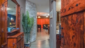 The hall with its stone details, and sliding custom barndoor to the bathroom.